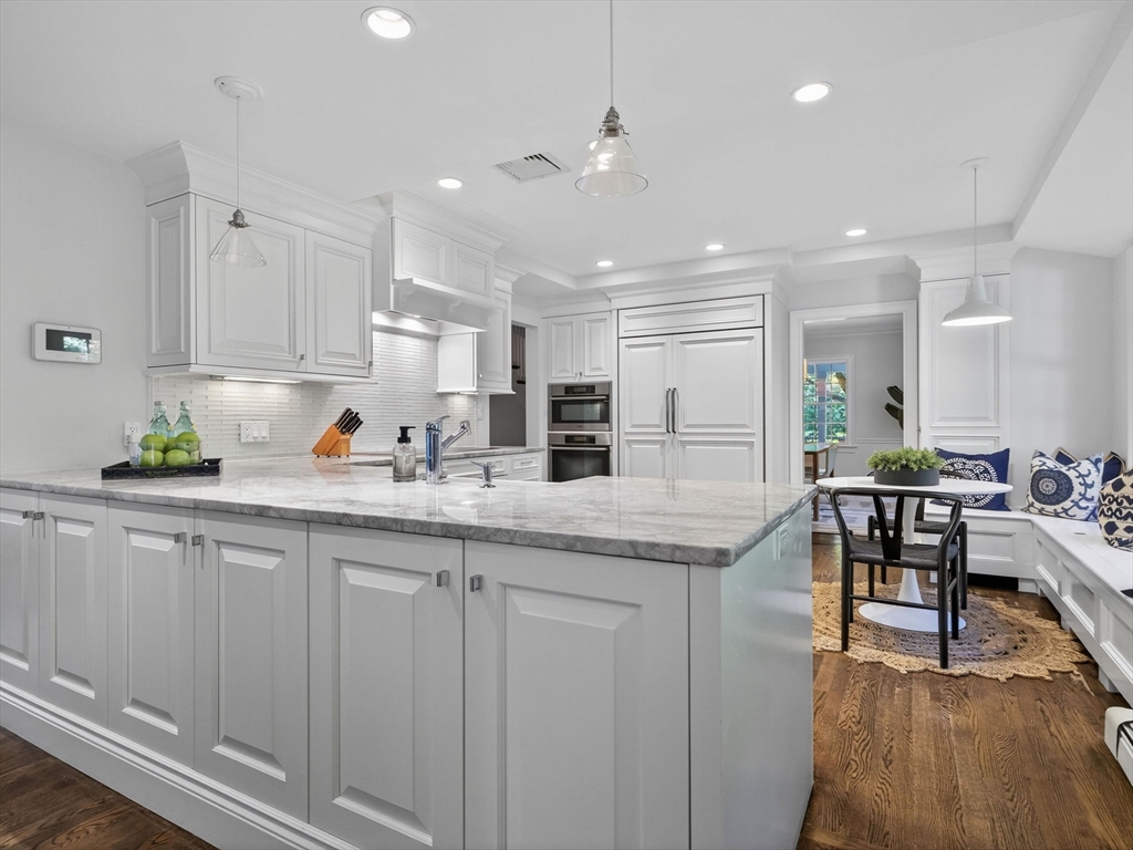 19 Marvin Road Wellesley, MA 02482 - Photo 5 of 33 a kitchen with granite countertop a sink and cabinets with wooden floor