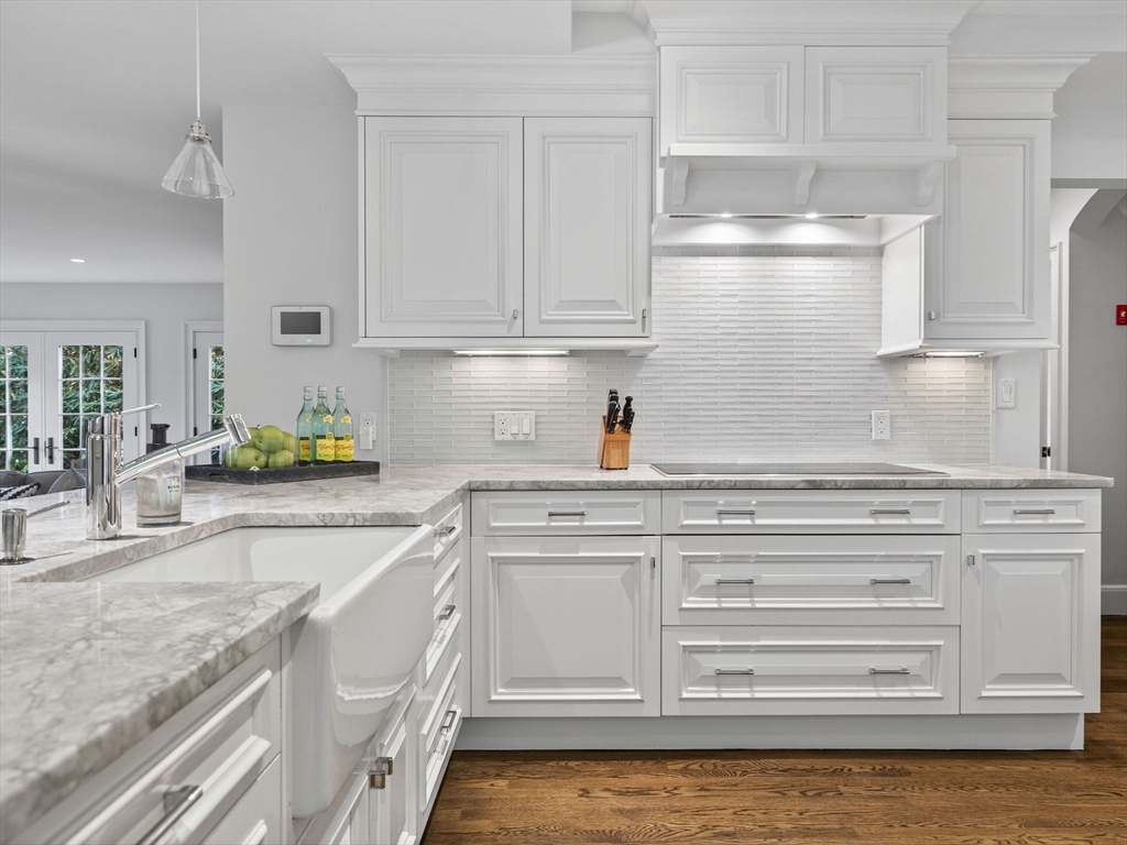 19 Marvin Road Wellesley, MA 02482 - Photo 6 of 33 a kitchen with granite countertop white cabinets and white appliances