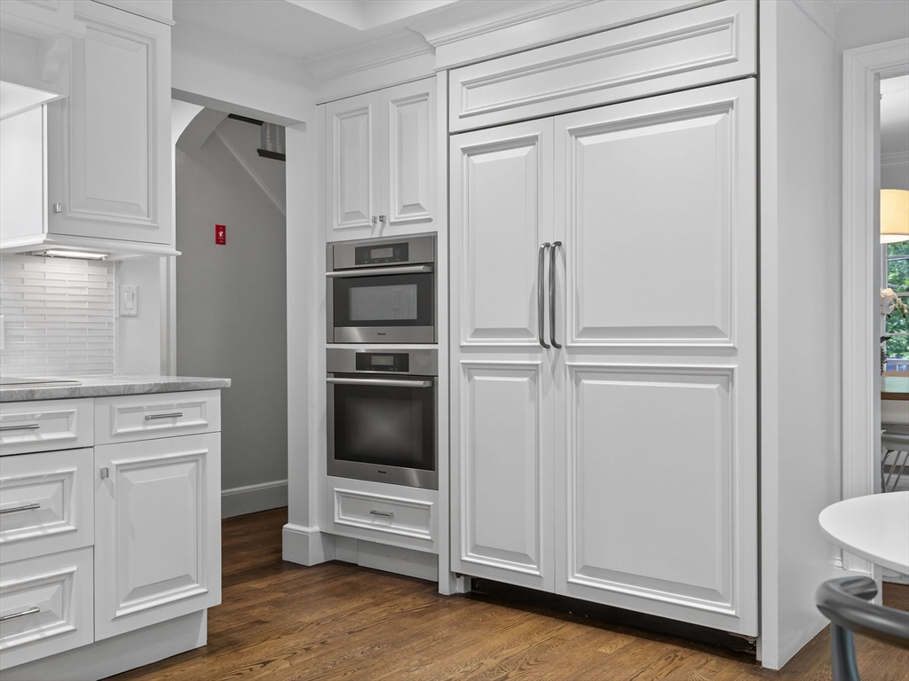 19 Marvin Road Wellesley, MA 02482 - Photo 7 of 33 a kitchen with white cabinets and white appliances
