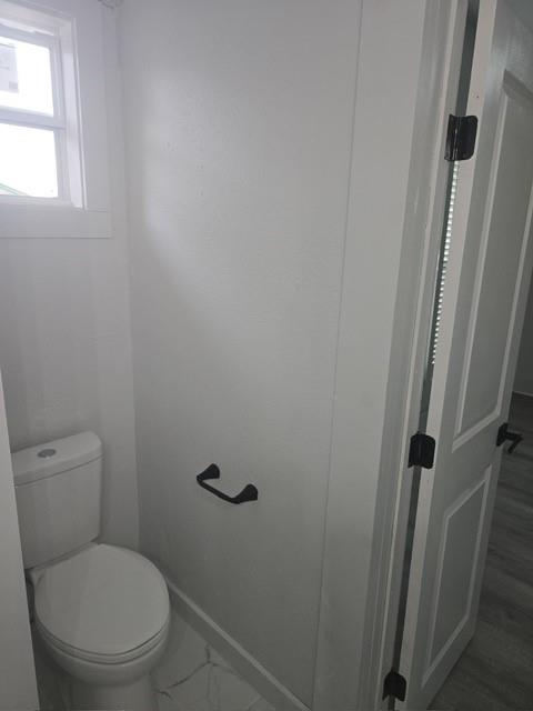 608 East Pecan Street Taylor, TX 76574 - Photo 12 of 25 a white toilet sitting next to a window