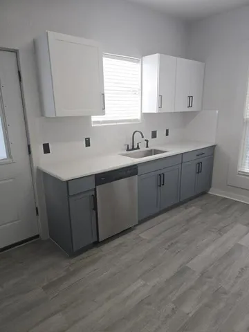 a kitchen with sink cabinets and window