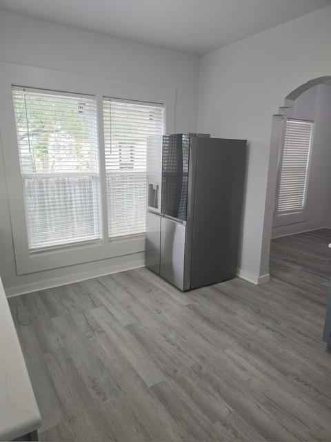 608 East Pecan Street Taylor, TX 76574 - Photo 15 of 25 a view of an empty room with wooden floor and a window