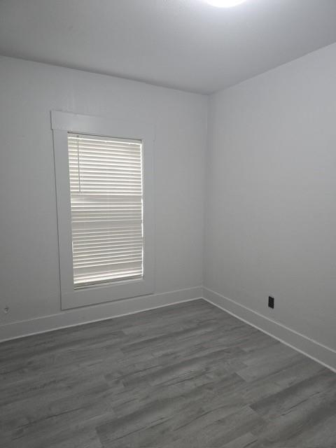 608 East Pecan Street Taylor, TX 76574 - Photo 19 of 25 a view of a small space with wooden floor and a window