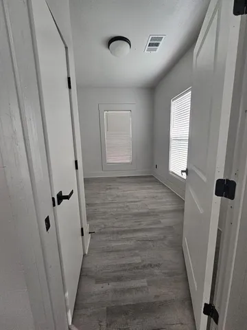 a view of room with window and wooden floor