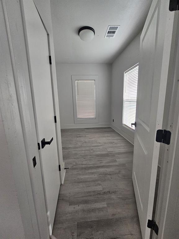 608 East Pecan Street Taylor, TX 76574 - Photo 25 of 25 a view of room with window and wooden floor