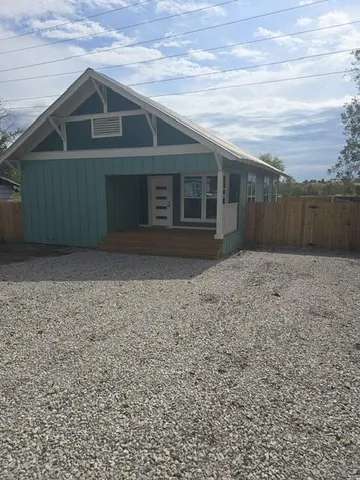 a view of house next to a yard