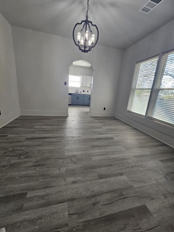 608 East Pecan Street Taylor, TX 76574 - Photo 5 of 25 a view of empty room with wooden floor and window