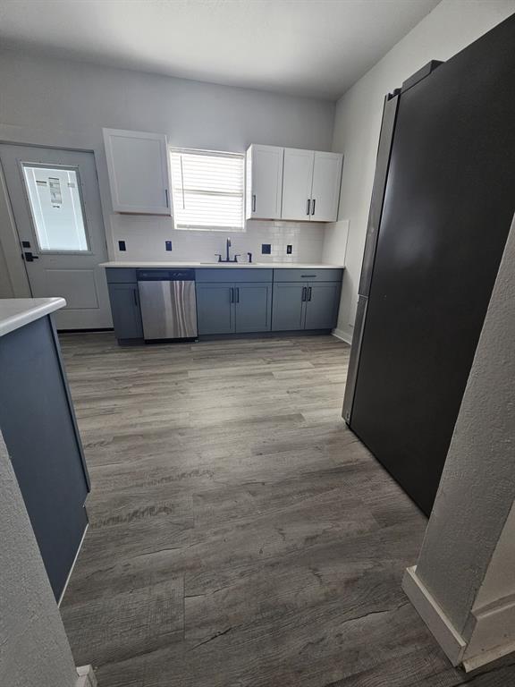 608 East Pecan Street Taylor, TX 76574 - Photo 7 of 25 a view of kitchen with wooden floor and electronic appliances