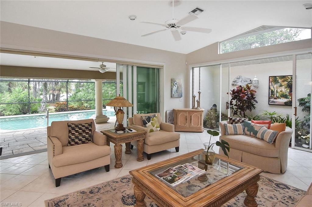 8928 Lely Island Circle Naples, FL 34113 - Photo 16 of 44 a living room with furniture and a large window