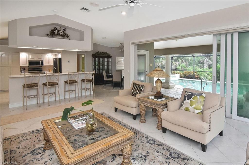 8928 Lely Island Circle Naples, FL 34113 - Photo 21 of 44 a living room with furniture and a table