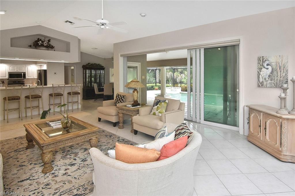 8928 Lely Island Circle Naples, FL 34113 - Photo 22 of 44 a living room with furniture and a fireplace