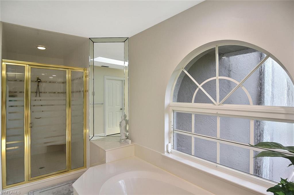 8928 Lely Island Circle Naples, FL 34113 - Photo 27 of 44 a bathroom with a window and a shower