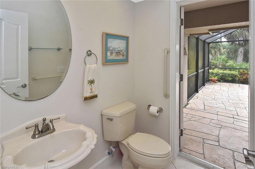 8928 Lely Island Circle Naples, FL 34113 - Photo 28 of 44 a bathroom with a sink a toilet and shower curtain