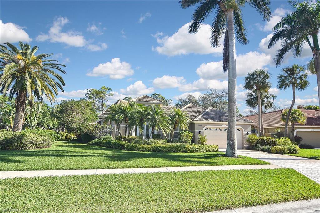 8928 Lely Island Circle Naples, FL 34113 - Photo 3 of 44 a view of a fountain in front of a house with a big yard