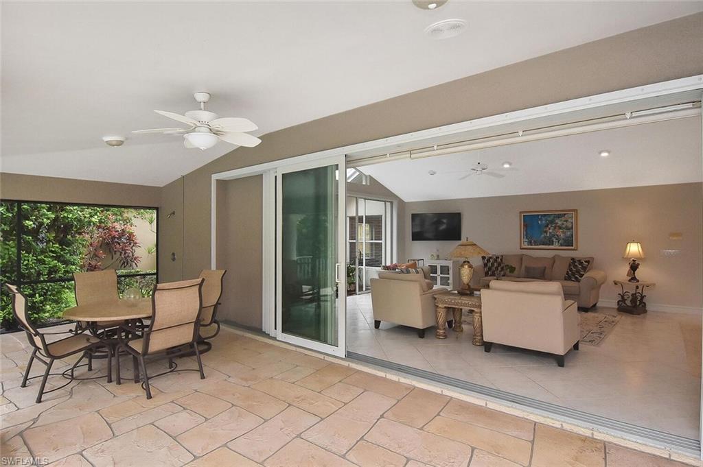 8928 Lely Island Circle Naples, FL 34113 - Photo 31 of 44 a living room with furniture and a large window