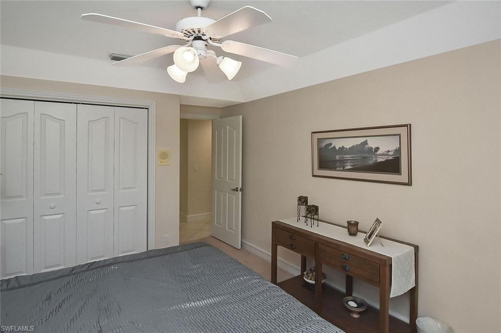8928 Lely Island Circle Naples, FL 34113 - Photo 34 of 44 a view of a workspace with furniture and a chandelier fan