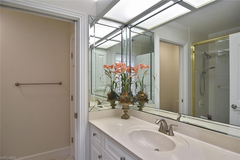 8928 Lely Island Circle Naples, FL 34113 - Photo 35 of 44 a bathroom with a sink and a mirror