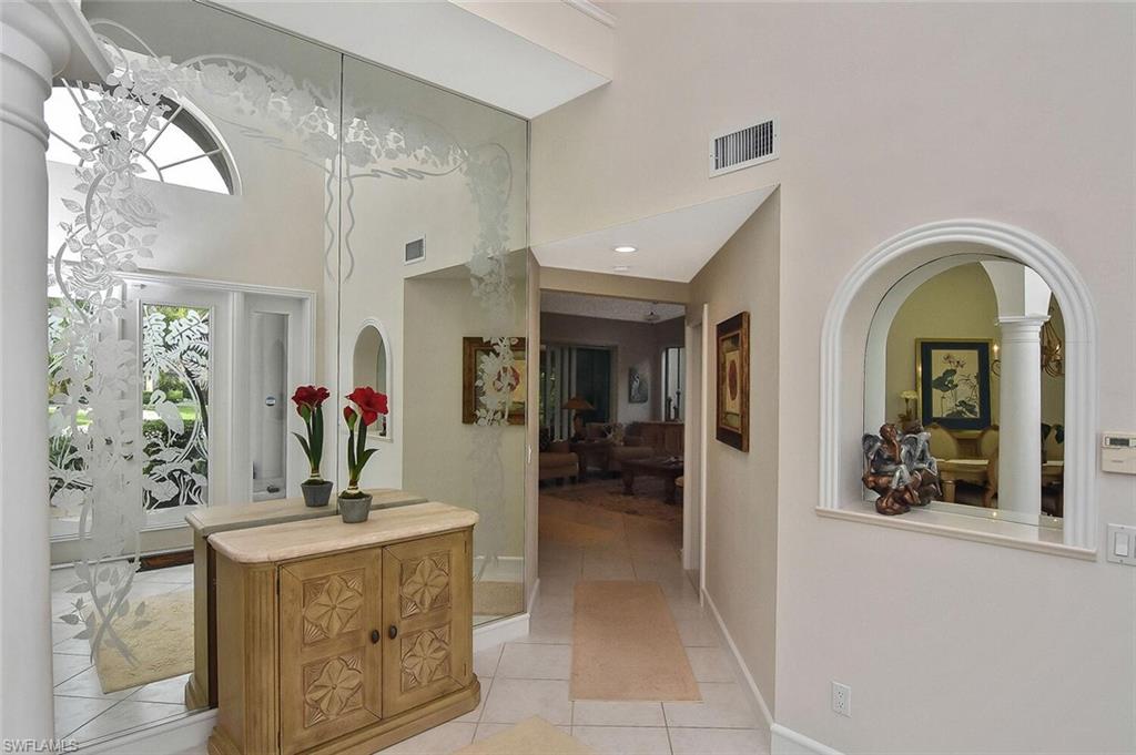 8928 Lely Island Circle Naples, FL 34113 - Photo 7 of 44 a view of living room kitchen with stainless steel appliances granite countertop furniture and living room view