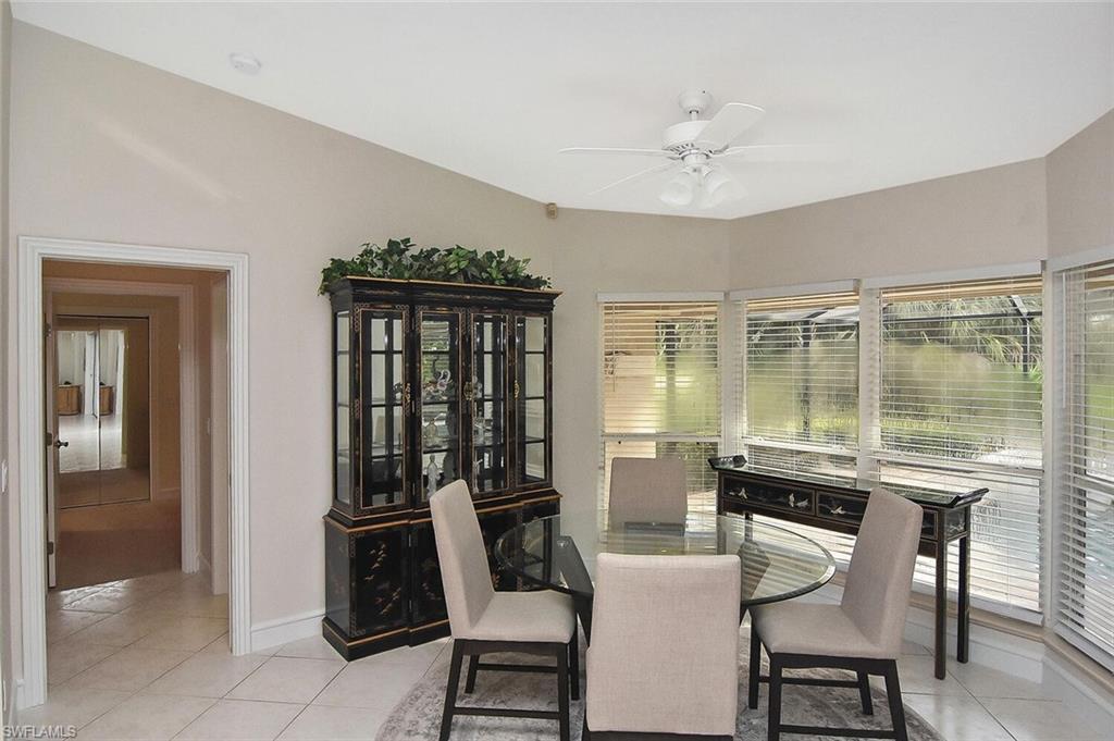 8928 Lely Island Circle Naples, FL 34113 - Photo 10 of 44 a dining room with furniture and window