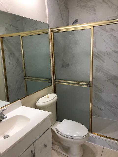 299 Southwest 7th Street, Unit 103 Boca Raton, FL 33432 - Photo 14 of 24 a bathroom with a sink a toilet and shower