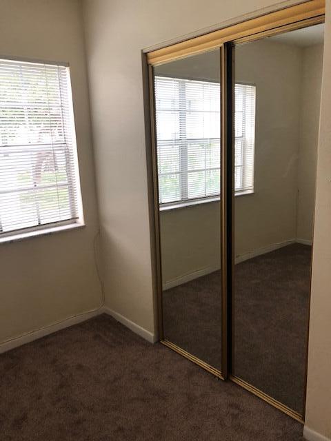 299 Southwest 7th Street, Unit 103 Boca Raton, FL 33432 - Photo 18 of 24 an empty room with a window