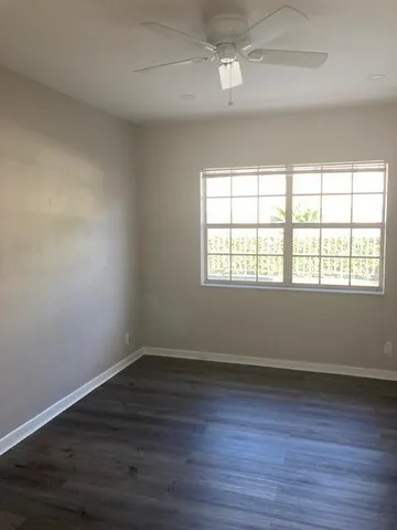 a front view of a house with a yard and balcony