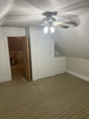 a view of a livingroom with an empty space and a ceiling fan