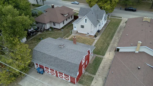 an aerial view of a house with a yard