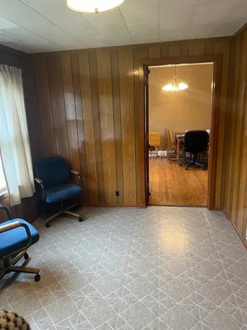 a view of a room with a window and a chair