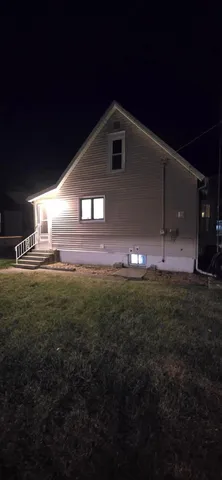 a view of a yard in front of a house with an outdoor space