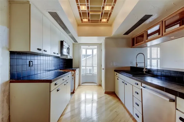 a kitchen with granite countertop a sink and cabinets