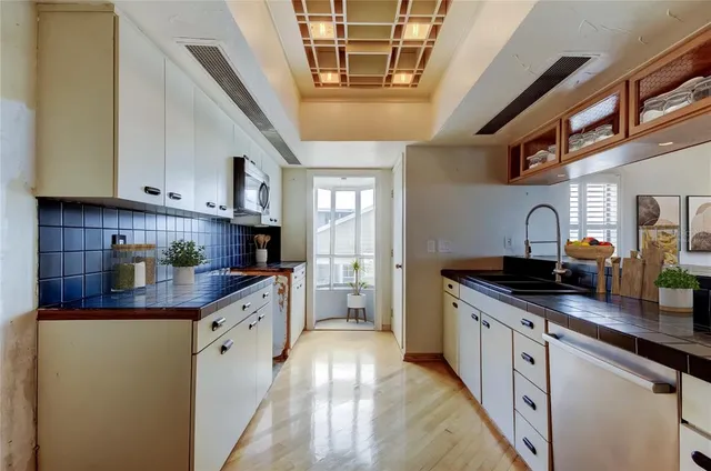 a kitchen with stainless steel appliances granite countertop a sink and cabinets
