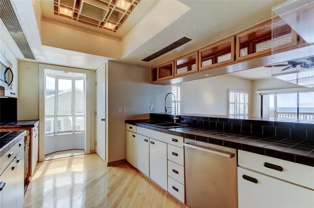 a kitchen with stainless steel appliances granite countertop a stove and a sink