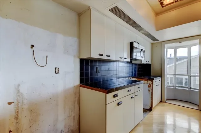a kitchen with granite countertop a stove and a sink
