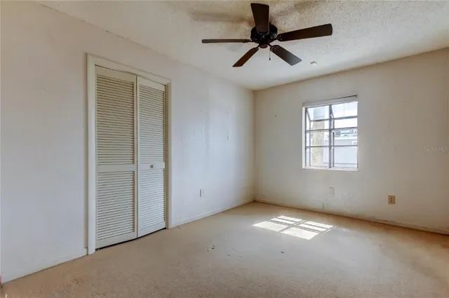a bedroom with a bed and a potted plant