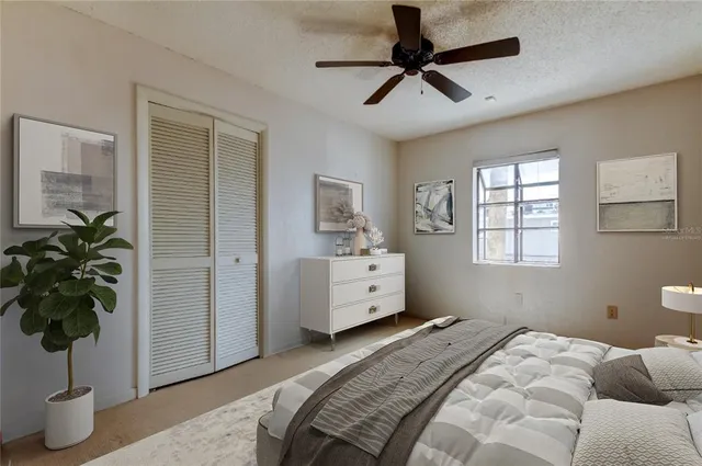 a view of a livingroom with a ceiling fan and window