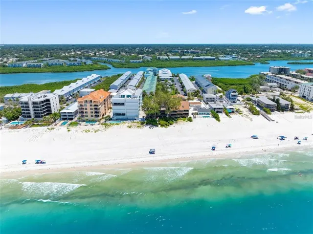 an aerial view of residential building and ocean