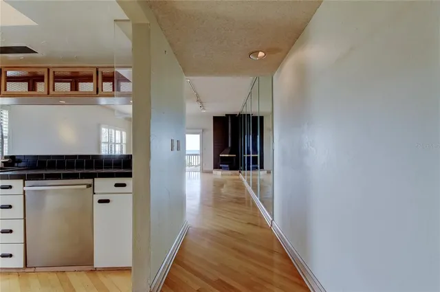 a view of a hallway with wooden floor and staircase