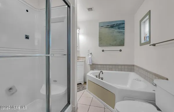 a white bath tub sitting next to a toilet