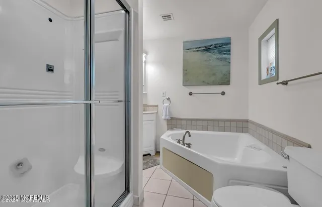 a white bath tub sitting next to a toilet