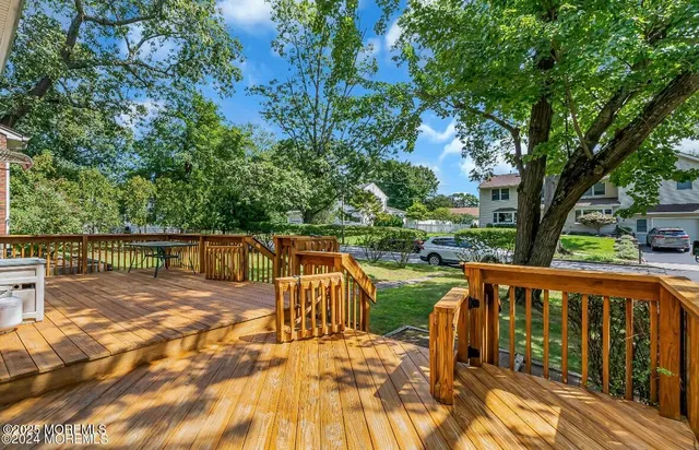 a view of a wooden deck with chairs