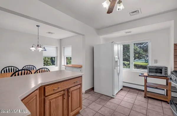 a kitchen with kitchen island a counter space a sink appliances and a window