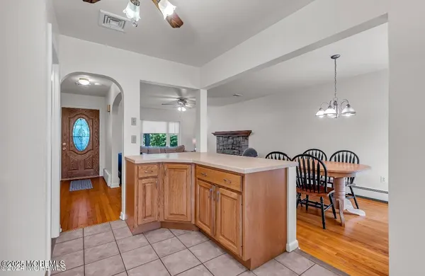a kitchen with granite countertop cabinets a dining table and a chandelier