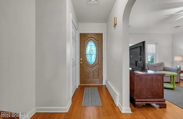 a view of living room with furniture and wooden floor