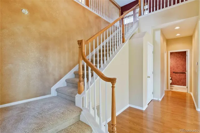 a view of entryway and hall with wooden floor