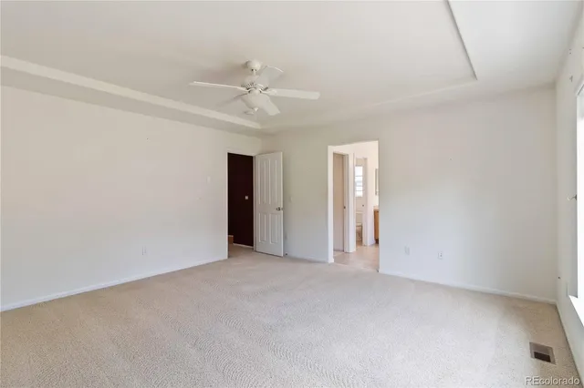 a view of an empty room with a ceiling fan