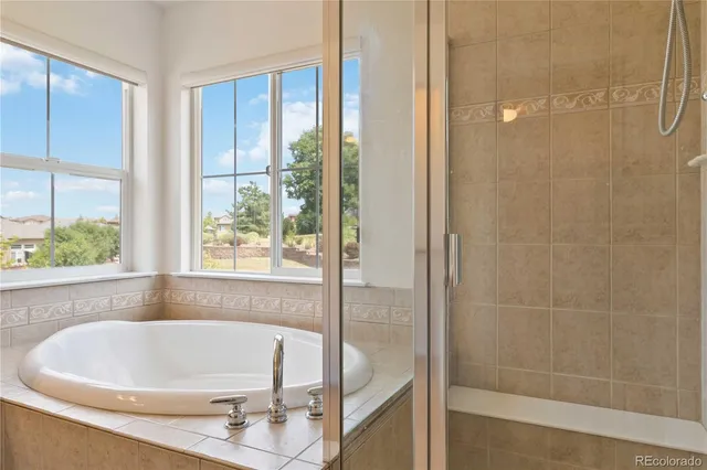 a white bath tub sitting next to a shower
