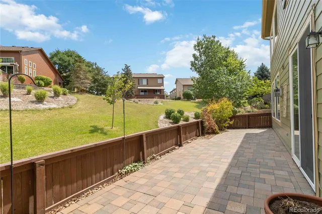 a view of house with backyard and garden