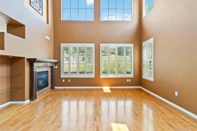 a view of an empty room with a fireplace and a window