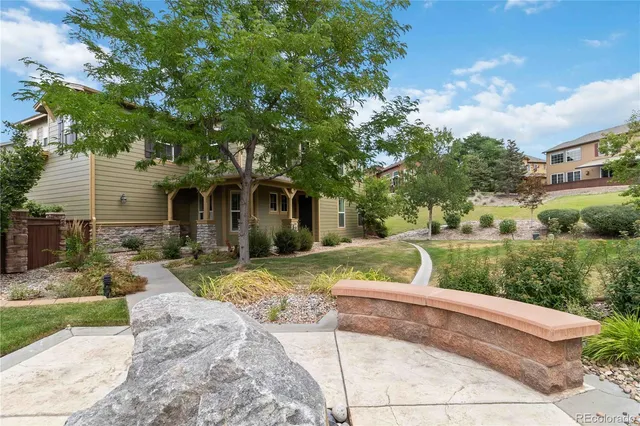 a view of a house with backyard and sitting area